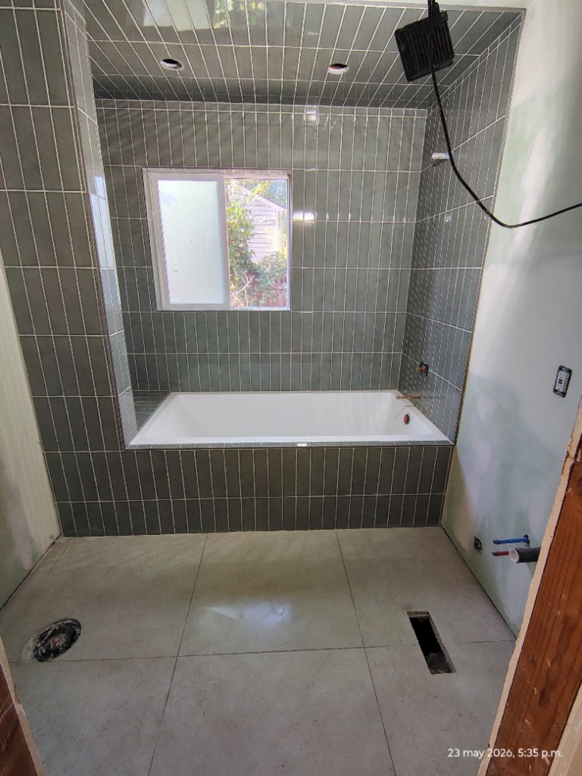 Green tile around the bathtub