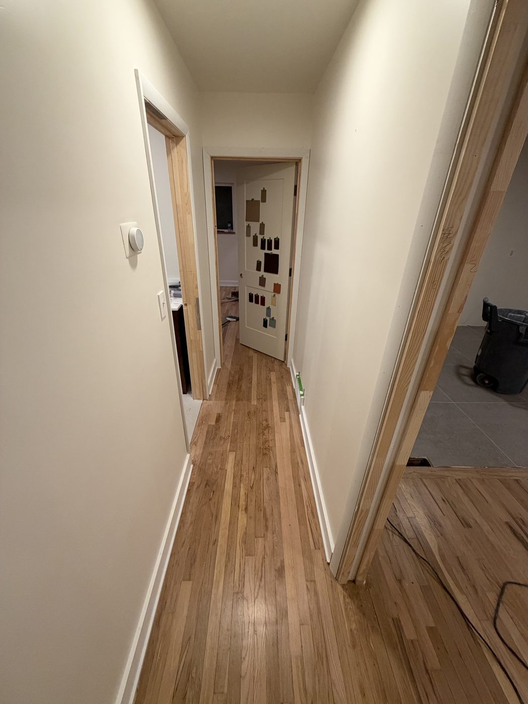 Sep 23, 2026. Hallway door casings still raw wood, with finish samples on a door