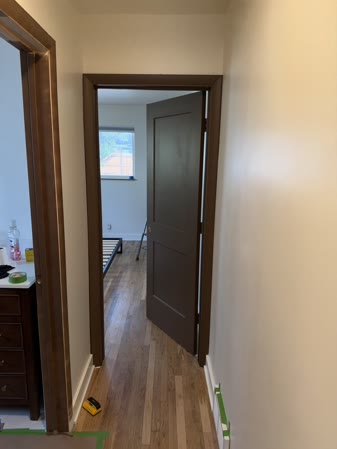 Sep 29, 2026. Brown bedroom door from the hall, with a glimpse of the bed frame