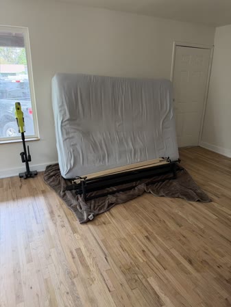 Sep 27, 2026. Mattress standing upright on a black bed frame with wood slats