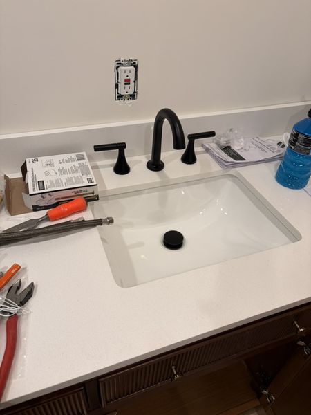Sep 5, 2026 — Black faucet and drain installed in the white bathroom vanity countertop