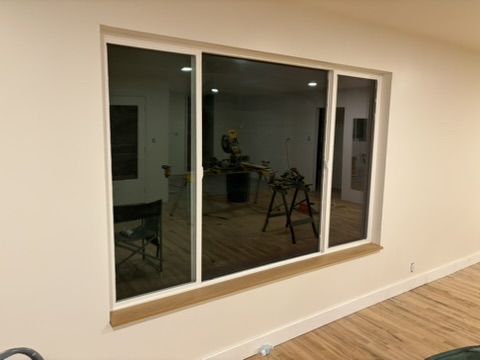Sep 2, 2026 — Wide three-panel window with a wood sill above the hardwood floor