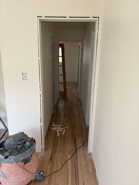 Aug 24, 2026 — Hallway with hardwood flooring and door jambs awaiting trim