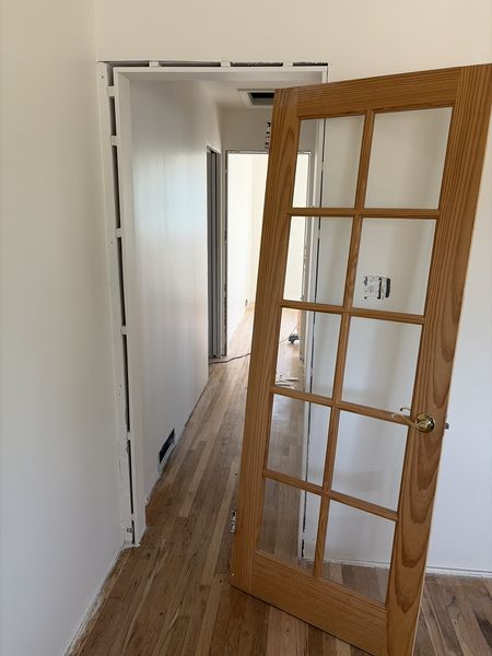 Aug 24, 2026 — Wood-framed glass door opening onto the hallway