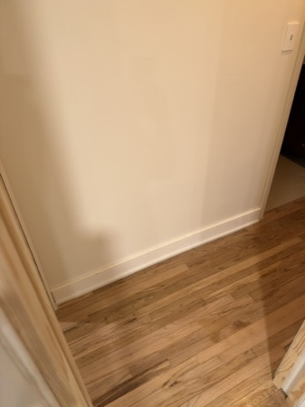 Sep 21, 2026 — Closet wall with finished baseboard, shoe moulding, and a white light switch cover