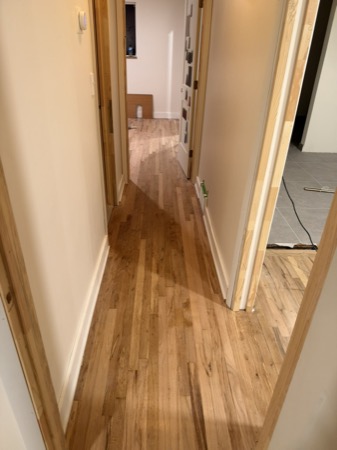 Sep 21, 2026 — Hallway with hardwood floors and white baseboards installed on both sides