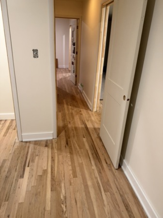 Sep 21, 2026 — Wider hallway view showing doors, baseboards, and remaining switch-cover work