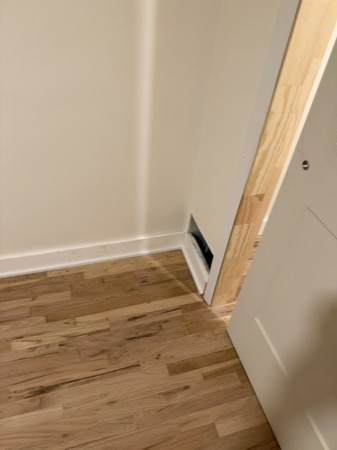 Sep 21, 2026 — Bedroom wall vent and hardwood floor with baseboard work underway